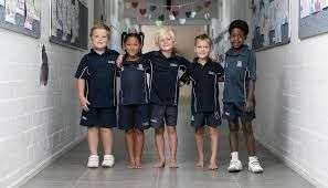 5 School children standing in School passage. Arms around each other