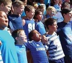School children standing together singing at a sports event at Topolino School in Langebaan