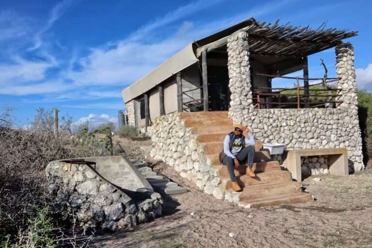 Love weskus ilove weskus iguest sitting on the steps leading to the entrance of the glamping tent and accommodation for self-catering at thali-thali game lodge