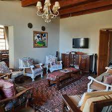 Love weskus ilove weskus ithe interior of the farmhouse at the thali thali game lodge with a selection of antique furniture, traditionally found in an old farmhouse. Chairs, carpets and lights