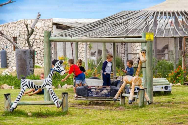 Love weskus ilove weskus ikids having fun and playing among wooden structures that represent animals to play with.