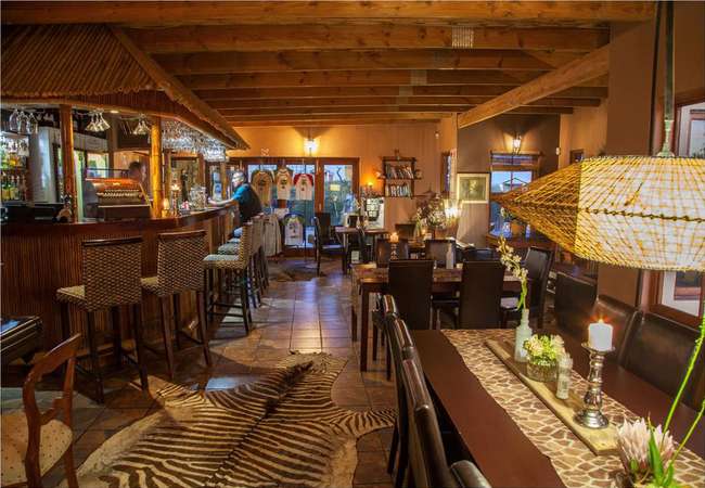 Love weskus ilove weskus ithe interior of the restaurant area at thali -thali game lodge, showing beautiful interior with interior you expect from high end game lodge at night.