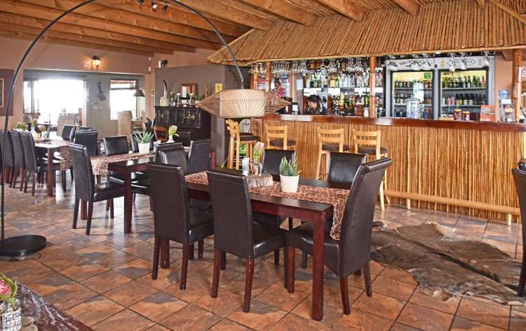 Love weskus ilove weskus ishowing the bar and seating available at this area with lots of wood interior and leather seats