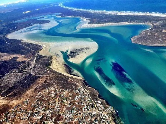 Iithe breathtaking view of langebaan over the lagoon with low tide, showing sand banks in the lagoon, beauty of langebaan contributing to the change in the langebaan demographic profile.