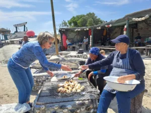 Iiguest being served with crayfish. Enjoy seafood at its best at outdoor restaurants in langebaan