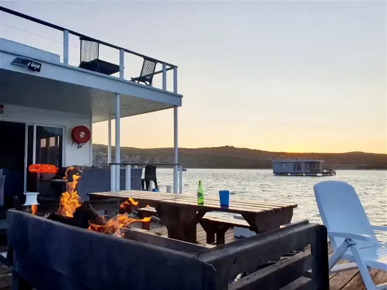 Iifire burning on the rear deck of the boat house in langebaan at sunset for perfect barbecue