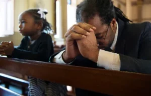 Love weskus ilove weskus ifather and daughter praying in a church, as they attend services by churches in langebaan