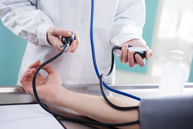 Iidoctors in langebaan are available to take assist with medical care as this doctor is taking blood pressure of a man in langebaan.
