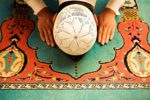 Love weskus ilove weskus ia muslim man doing praying on a colourful carpet with face to the ground as the islamic church in langebaan