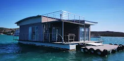 Iithe front view of the larus boat house in langebaan, floating on the lagoon