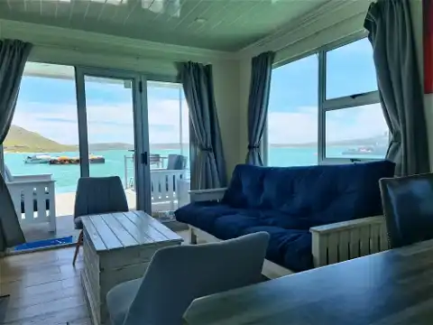 Iithe spacious lounge with views of the lagoon from the serenity boat house in langebaan