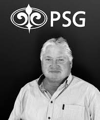 Black-and-white portrait of a middle-aged man in a light shirt with the PSG logo behind him.