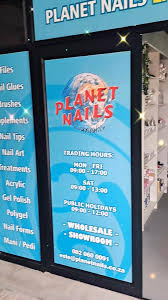 Planet Nails storefront sign on a blue panel showing hours of operation (Planet Nails)