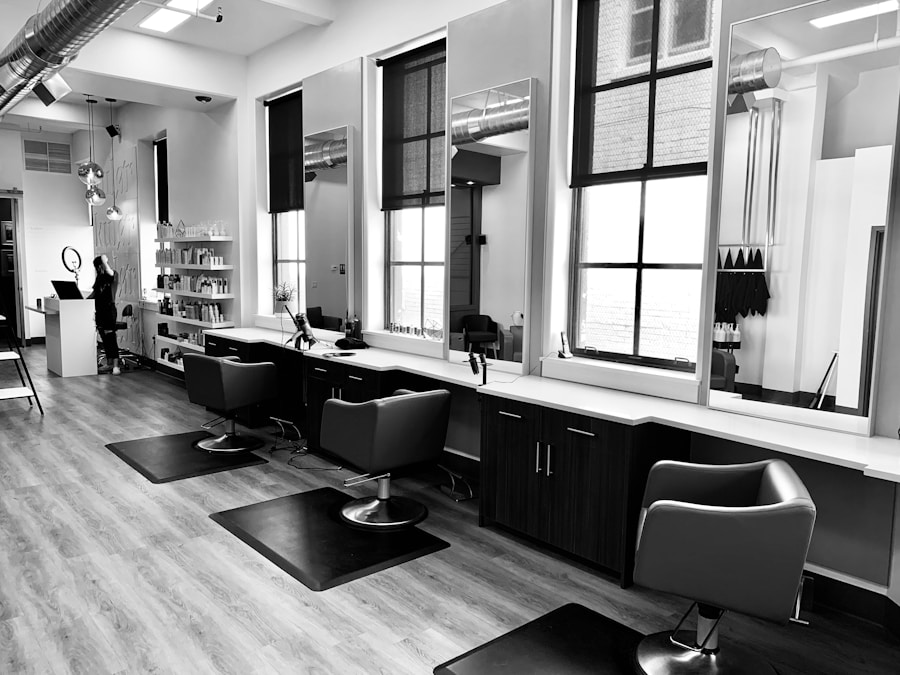 Wellness-hair-salon-1 jpg – – Iihair salon interior with row of styling stations, mirrors, and chairs along a long white counter; shelves with products in the background (black-and-white photo).